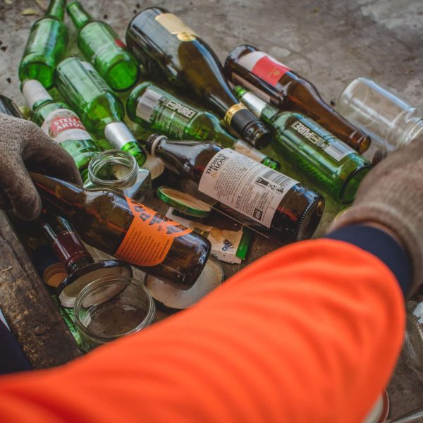 Hand-sorting glass recycling PC Wastebusters